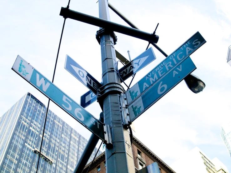 an intersection sign with two street names mounted to a lamp post