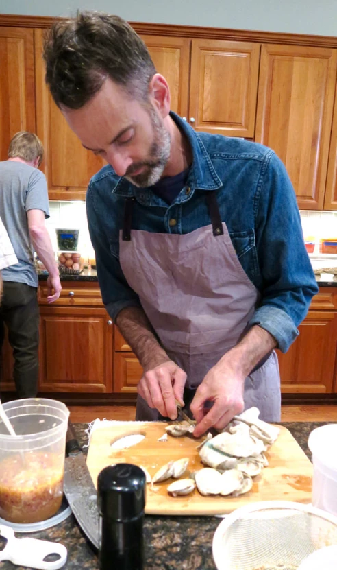 a man in a blue shirt and an apron