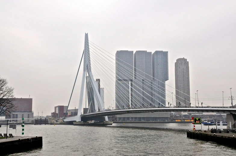 a large bridge over some water next to buildings