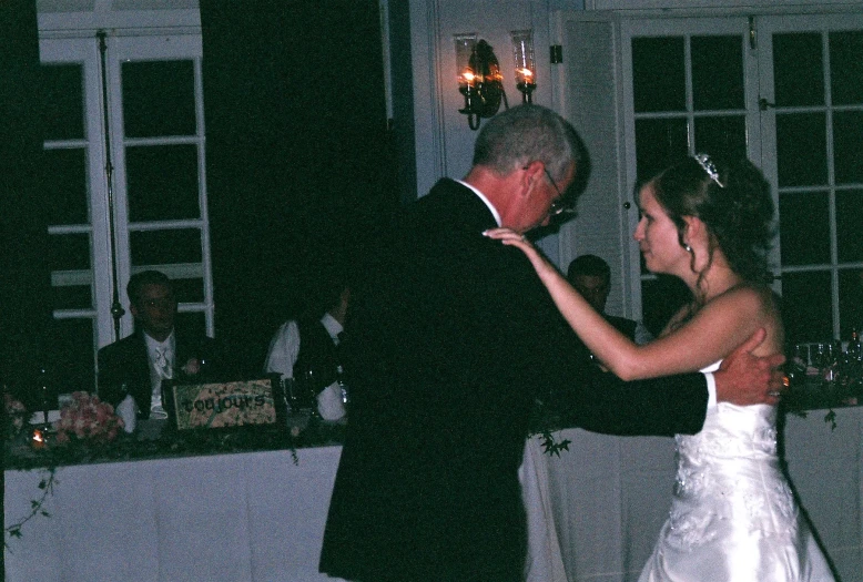 a man and a woman dance together during a wedding