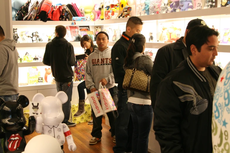 group of people standing around inside a toy store