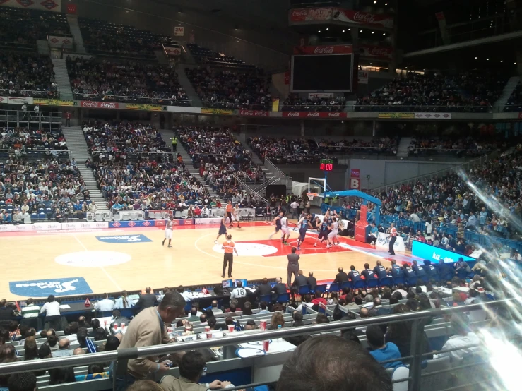 several people on a basketball court, all standing up