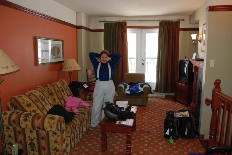 a woman stretching and standing in a living room