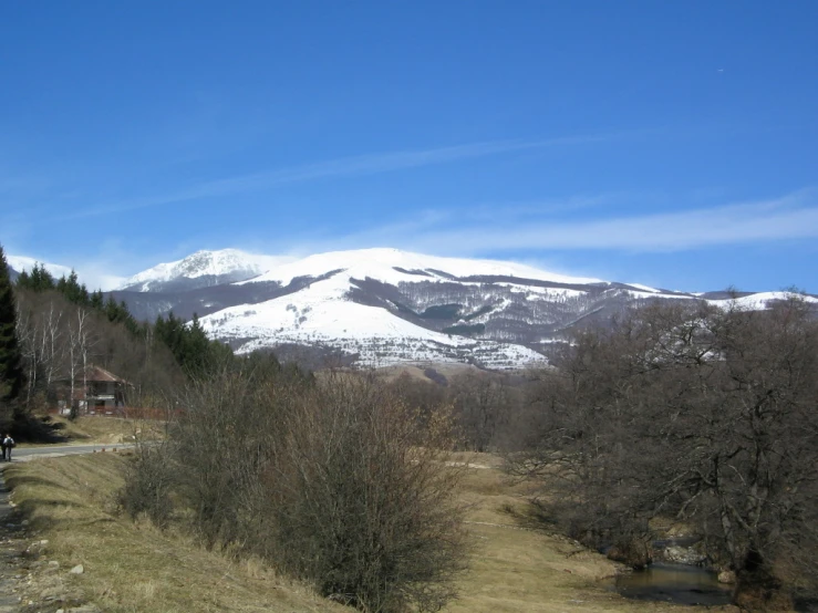 a snowy mountain is in the distance on a sunny day