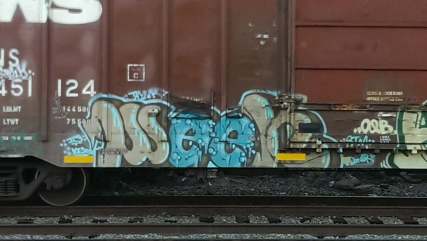 an image of a rail car in graffiti