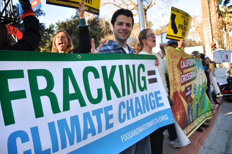 a group of people are holding up protest signs