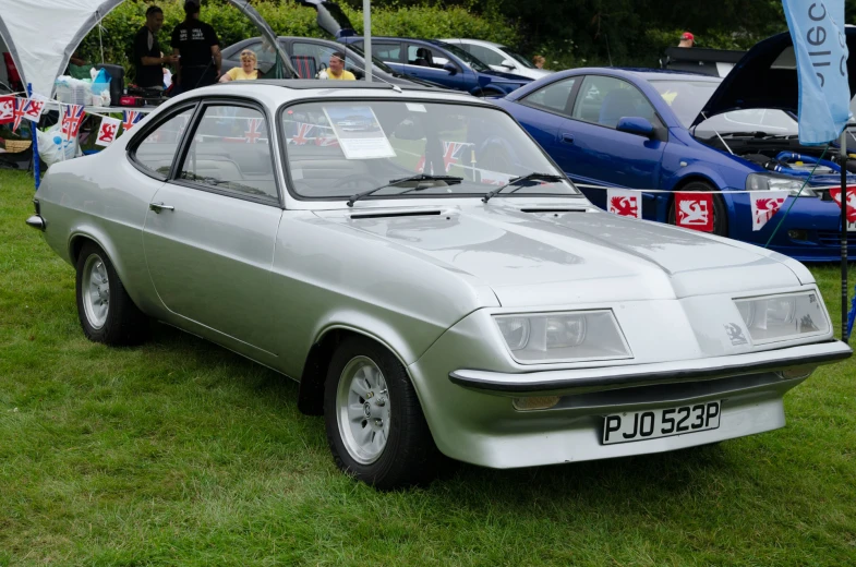 old style car displayed at auto show in grassy area