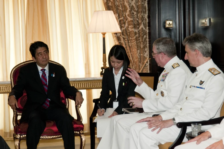 four people in military uniforms sit with one another