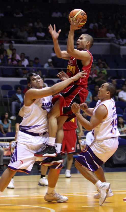 a group of people in uniforms playing basketball