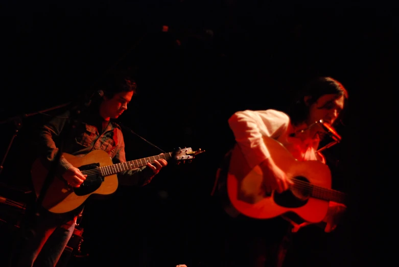 a couple of people are on stage playing instruments