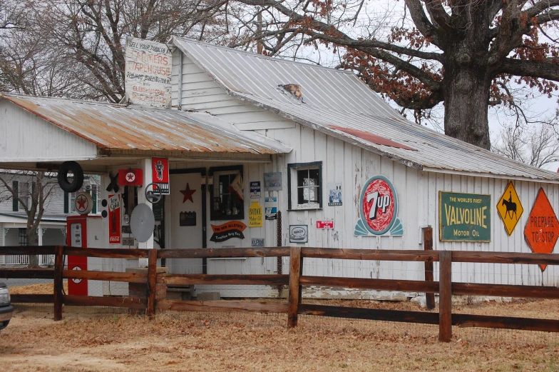 a white shop with signs and pictures on the facade