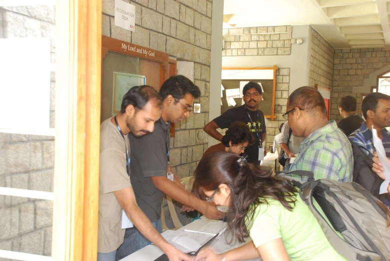 a group of people at a door with a woman  soing