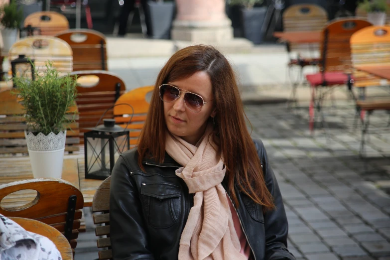 a woman sitting on a bench in a park