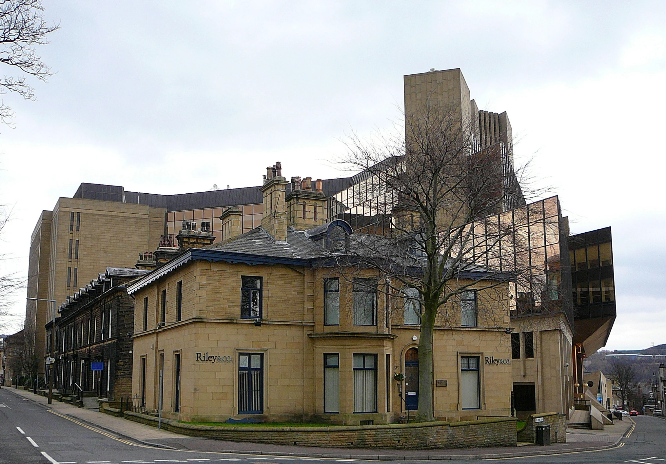 an old building with a large chimney and tree