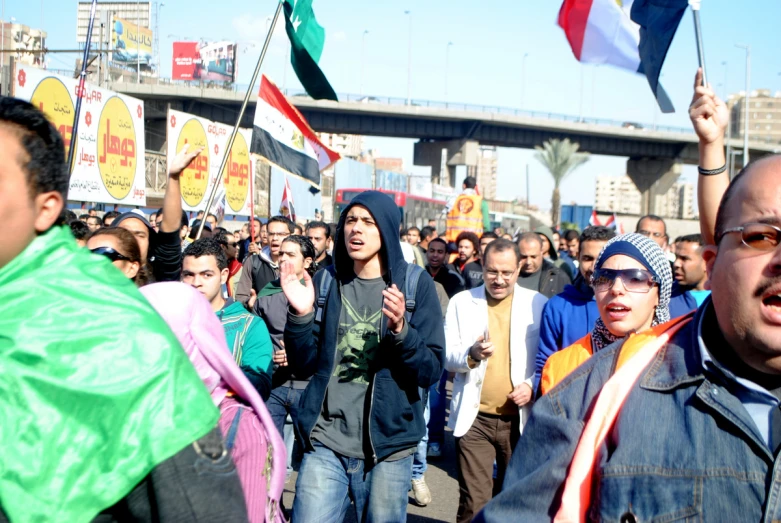 a group of people are holding flags while they walk