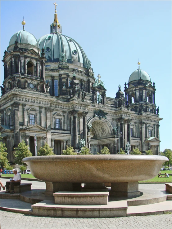 a large building with a big stone water feature