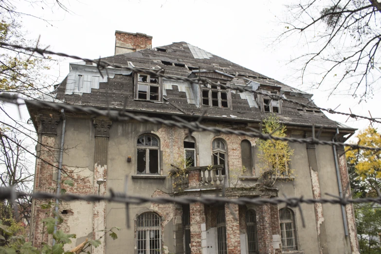 a rundown brick house has broken windows