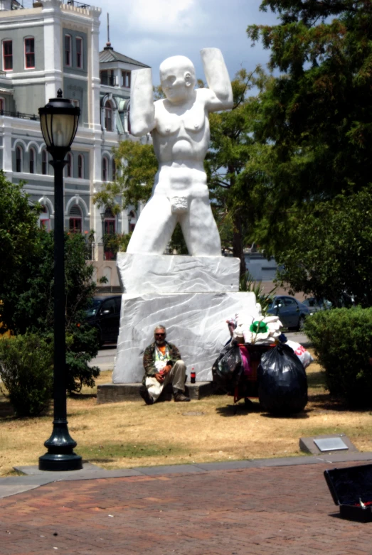 there are two men standing by the large statue