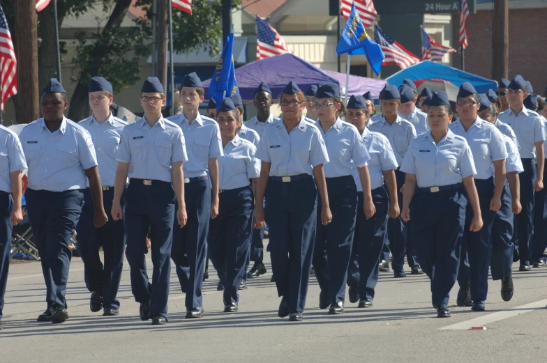 people marching down the street in uniforms