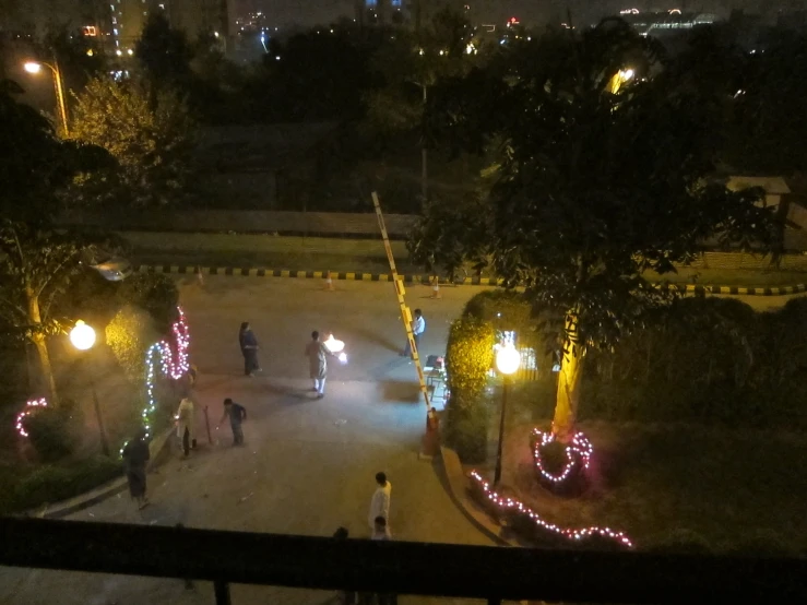 group of people walking on sidewalk during night