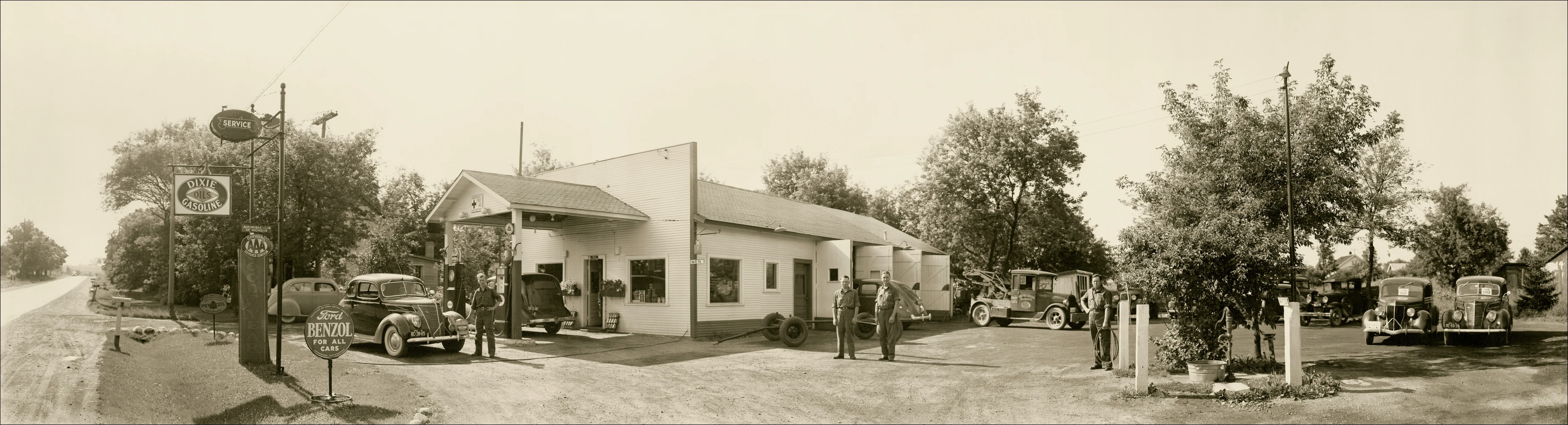 a sepia po of people gathered outside a small house