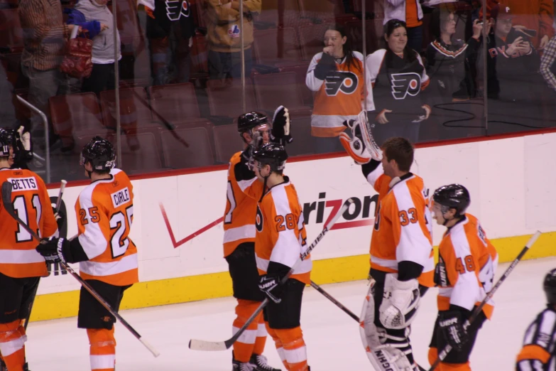 a group of people on a rink playing hockey