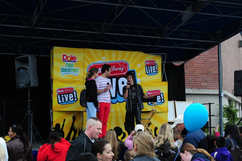 people gathered around to see an event on stage