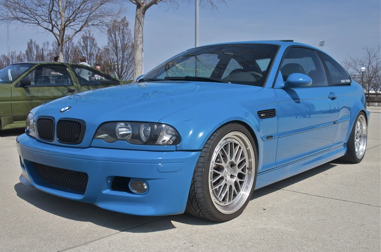 a blue bmw car parked on a street