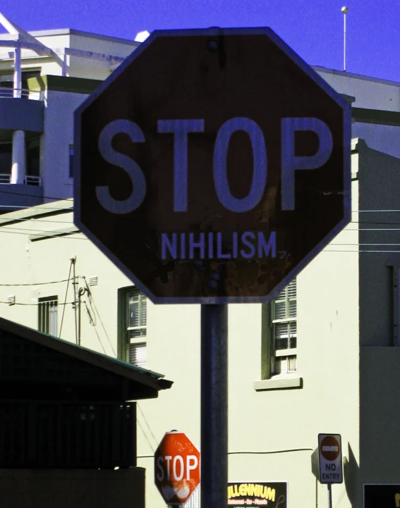 a stop sign with an ad that reads capitalism and a graffiti on it