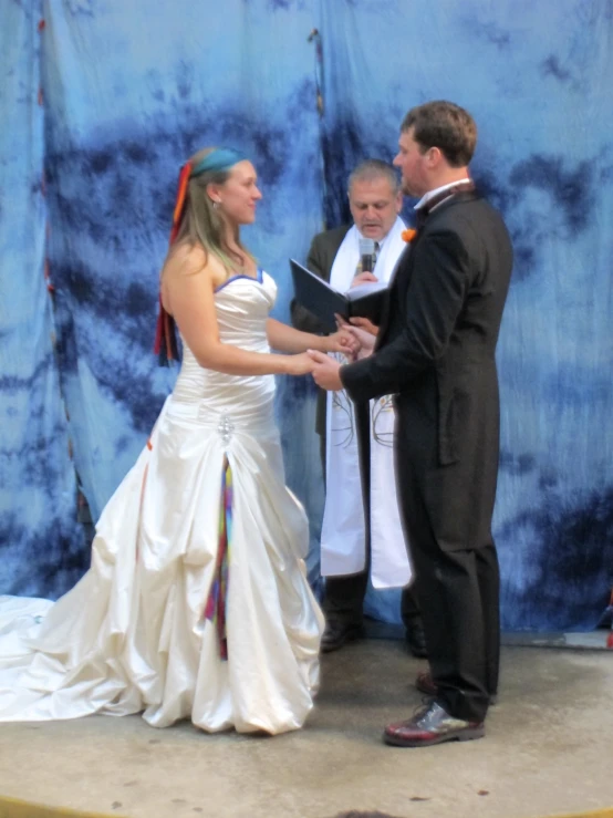 a bride and groom are exchanging during a ceremony