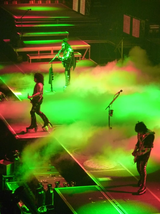 the band is performing with some colored smoke