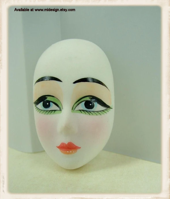 a doll head with makeup on top and eyebrows