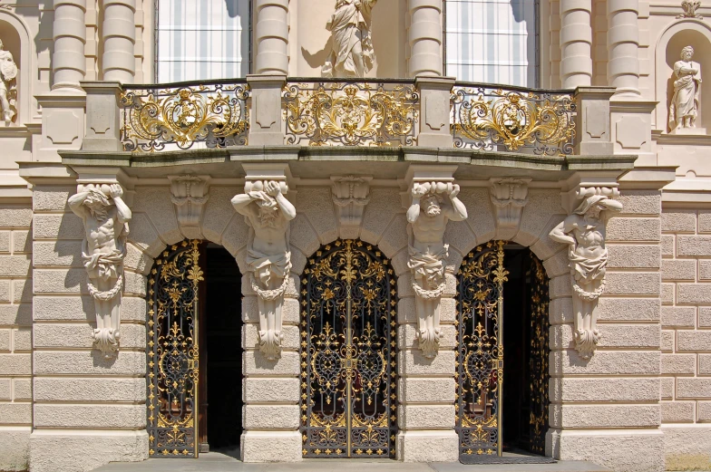 a red fire hydrant on the side of a building with ornate gold decoration