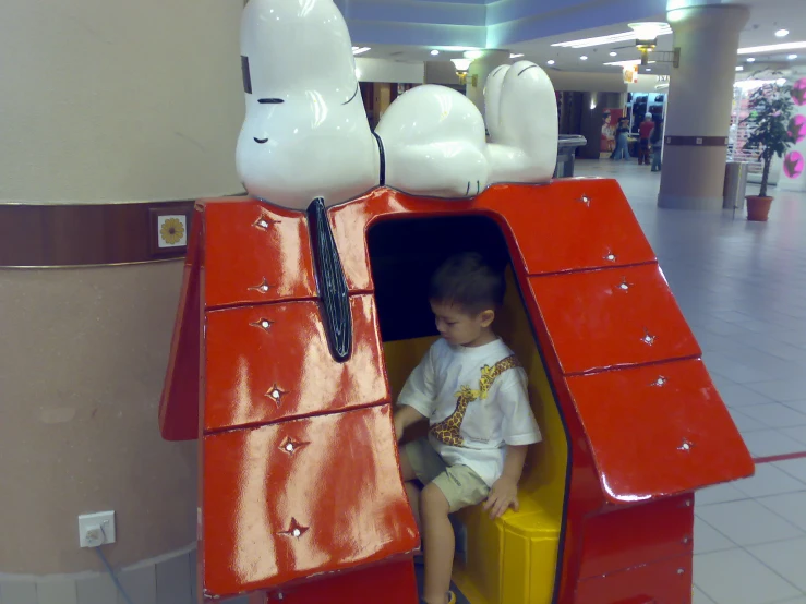 small child on a large wooden toy train
