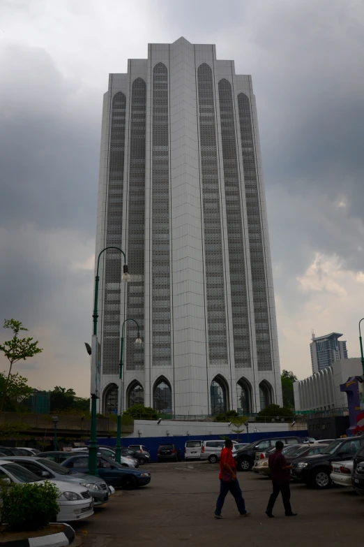 two people walking by some very tall buildings