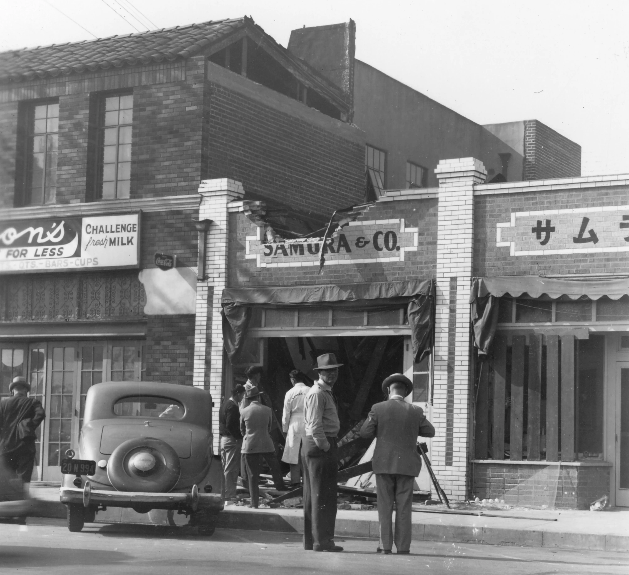 some people and an old car on the street