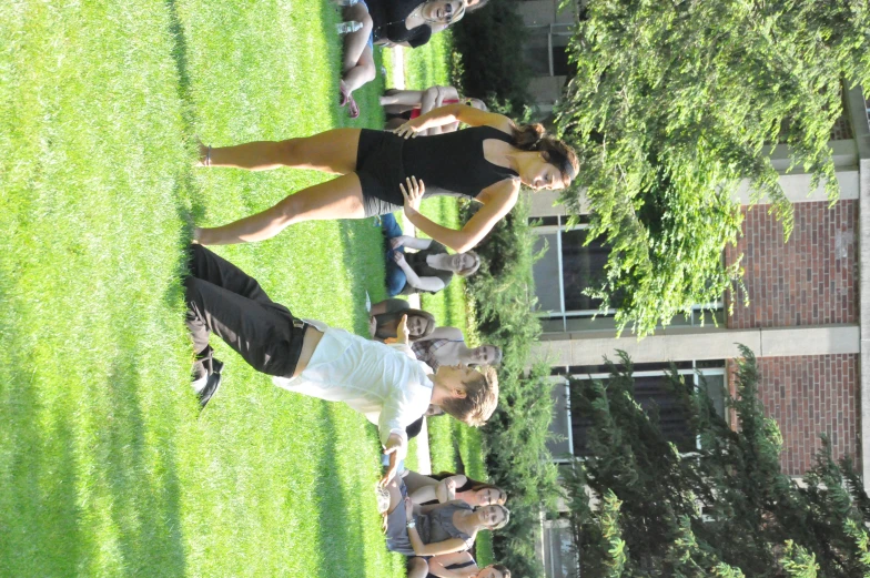 the woman is leaning over to get into the frisbee