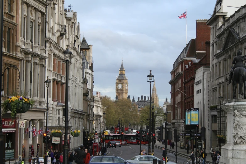 a long city street with traffic and an historic building