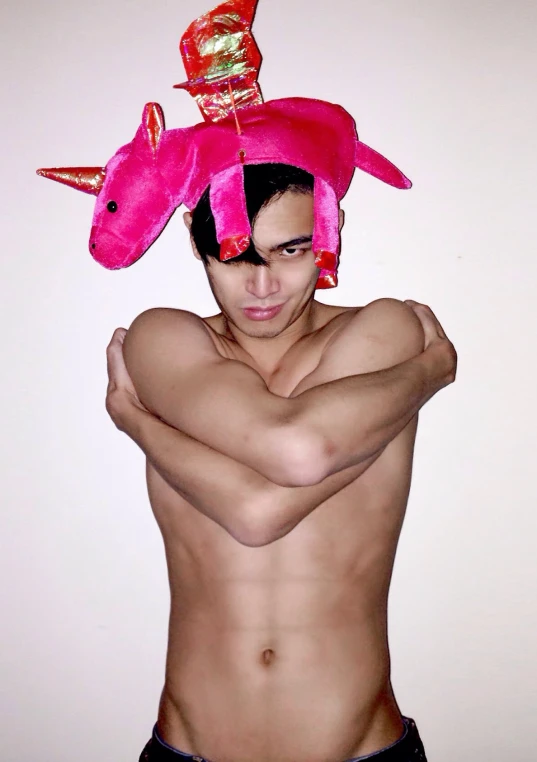 a man that has  on with a pink animal on top of his head