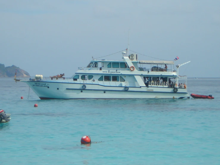 several boats are anchored in the clear water