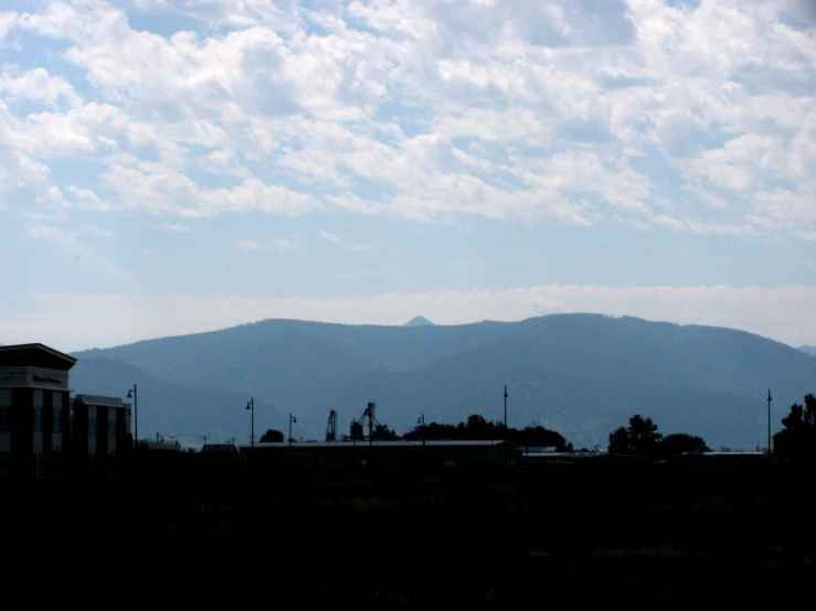 a train is parked near mountains on a sunny day