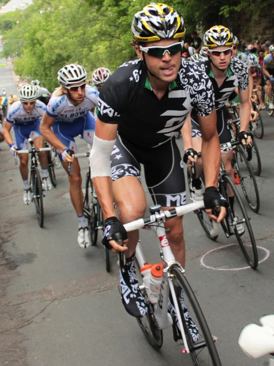 a group of bikers are riding down the street