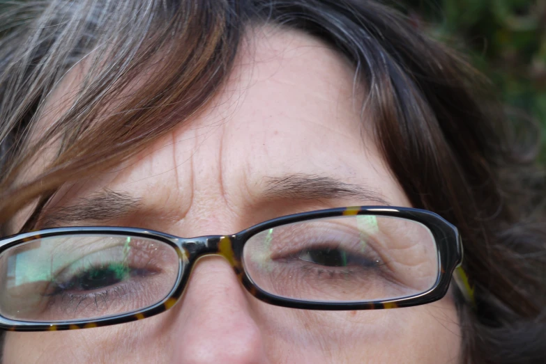 close up image of a woman with glasses on