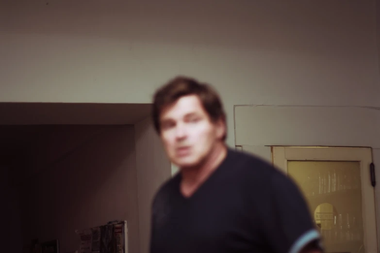 blurry image of person standing in a room