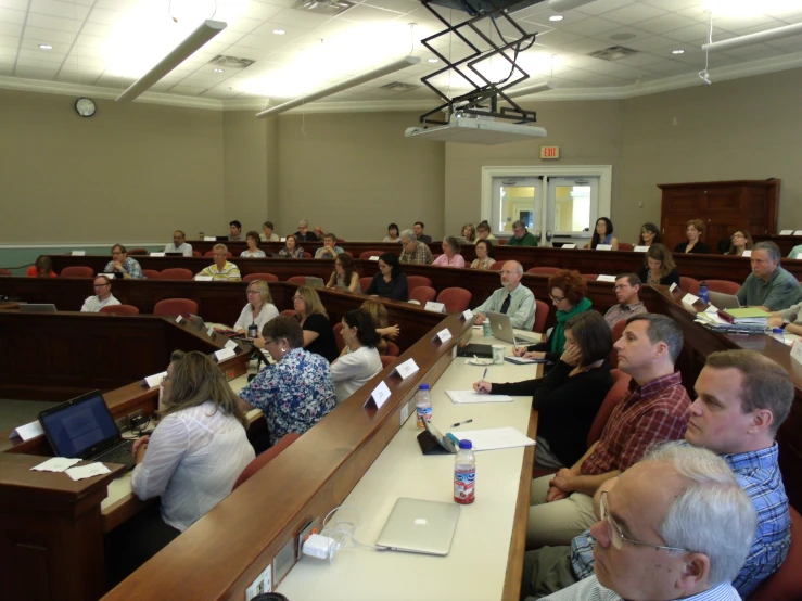 a group of people seated in the courtroom during an meeting