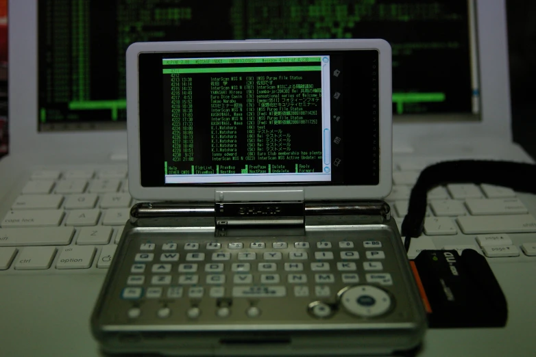 a close up of a laptop computer near a keyboard