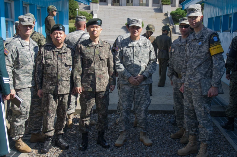 military men in uniforms posing for a picture