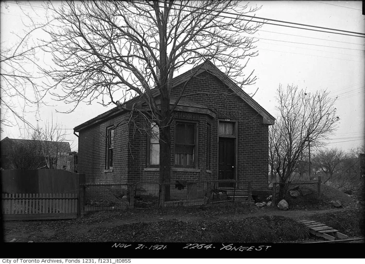 the house is sitting alone by the street