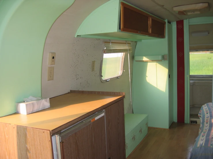 a kitchen area with cabinets inside of an rv