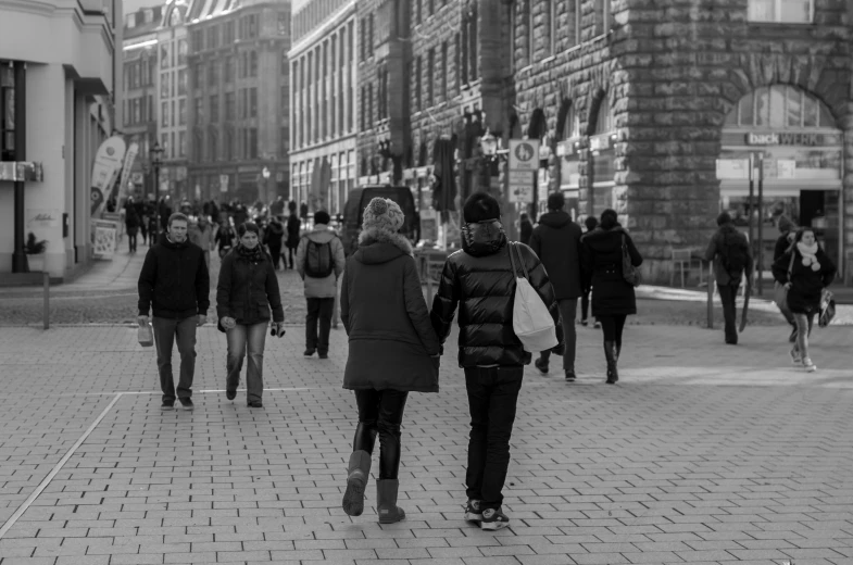 people walking down the street in black and white